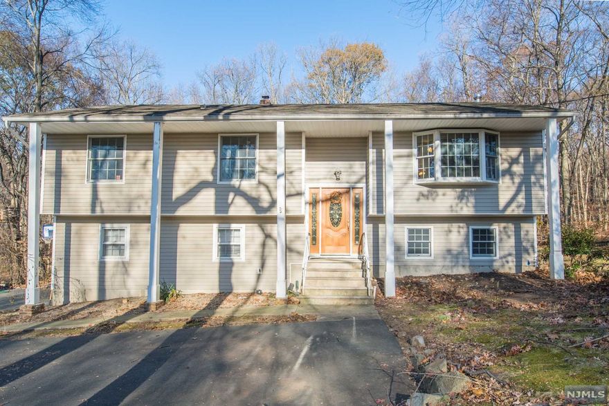 PROFESSIONALLY CLEANED TOP TO BOTTOM, INSIDE AND OUT, PROFESSIONALLY LANDSCAPED & PROFESSIONALLY POWER WASHED (siding & roof). Lots of Generous Room Sizes to Spread Out & Make Your Own! Layout offers versatile options! Ground level IN-LAW SUITE w/sep entrance & full kitchen! GREAT house for entertaining or everyday living. Hardwood Floors. Great living space w/wood burning stove. Oversized family room w/high ceilings appointed w/custom palladian windows & sliding glass doors leading to 2 story, trex style deck. Super functional kitchen w/NEW SS appliances, quality wood cabinets, granite & bfast bar. Opens to dining & living areas. 3 large bedrooms & 2 full bath upstairs includes the master suite w/private access to the back deck. 4th bedroom & bath on lower level. Fully equipped in-law suite on ground floor w/sitting area & walkout to backyard. Over 2500 square feet. Heated 2 car garage w/workshop. Plenty of storage space in the attic, garage or storage shed.