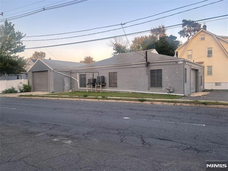 Corner industrial building offering just over 3,000 sq ft of ground level space plus additional second floor area currently used for storage and shipping. Features include a private office, restroom, and central air for year-round comfort. Property is equipped with an alarm system and provides excellent visibility on a corner lot. Previously used as an auto body repair service, this building offers many possibilities and flexible options for the new owner. Plenty of parking available and conveniently located close to major transit routes.