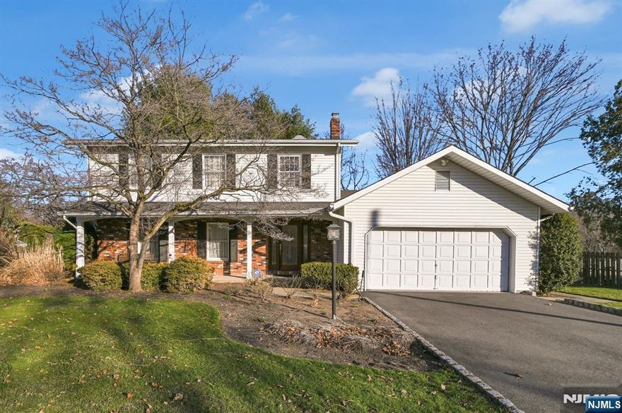 Come Fall in Love with this Beautiful Custom Colonial, perfectly set on a large flat corner lot. Spacious 1st floor layout featuring bright & sunny living room with recessed lighting. Formal Dining Room. Modern Kitchen with custom cabinets with granite counter tops, double wall oven, gas stove top, Dining area of kitchen leads to French doors to sunroom with sliders to deck. Family room with gas fireplace with built in's. 2nd level features 4 bedrooms, main bath with washer & dryer closet. Primary Bedroom offers walk in closet, newer primary bath. Gleaming hardwood floors thru out the living area. Kitchen & baths are tiled. Full unfinished basement. Oversized 2 car garage with epoxy coated floor & Storage cabinets. Cental Vac, & A/C.