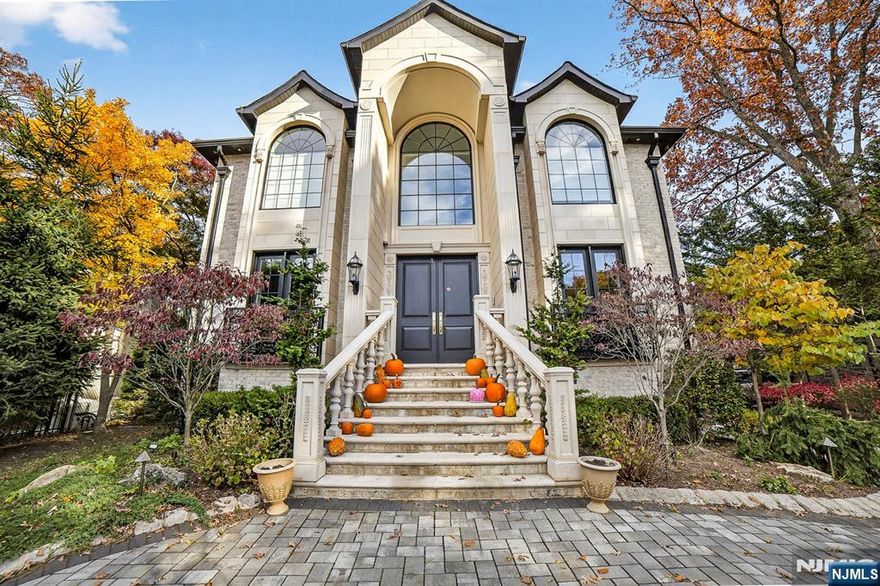 Step into exceptional luxury with this 5-bed, 4.5-bath center-hall Colonial that blends timeless elegance with modern sophistication. The grand two-story foyer features a sweeping curved staircase, soaring ceilings and rich architectural woodwork, including beautifully detailed coffered ceilings. The chefâ€™s kitchen is a showstopper, highlighted by a leathered-granite waterfall island, designer cabinetry and premium appliances, ideal for both entertaining and everyday living. The home is fully equipped for the contemporary lifestyle with advanced smart-home automation, high-end security features and multi-zone heating and cooling for total comfort and control. Outside, discover a true private oasis: a pristine gunite pool, spa-style hot tub and lush landscaping create a resort-like setting for recreation and relaxation. Craftsmanship and convenience meet in this exceptional estate.