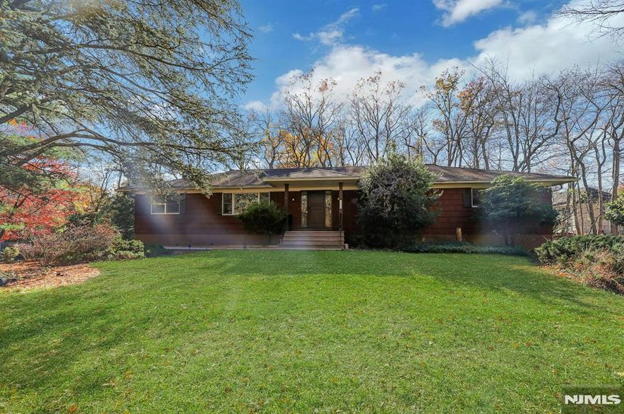 Beautifully renovated, expansive Ranch offering over 2,400 square feet of sun-filled living on one level. This home features an open-concept kitchen and family room, hardwood floors throughout the main living areas, and generous formal living and dining rooms that create an ideal flow for everyday living and entertaining. The chefâ€™s kitchen boasts a 6-burner Viking range, center island, white shaker cabinetry, and granite countertops, opening to a spacious family room with stone fireplace and sliders to a large deck overlooking a private, wooded backyard. Four bedrooms include a serene primary suite with renovated en-suite bath. Convenient main-level laundry. Full unfinished basement with wood stove and direct access to a two-car garage offers endless potential. Ideally located across from protected woodlands for privacy, yet close to shops, dining, and major highways including GSP and Palisades Parkway. NOTE: House has well water, not municipal water.