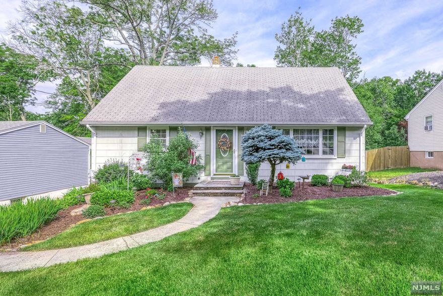 Much larger than it appears, this 4-bedroom, 2-bathroom cape is sure to please! Enter into your formal living or dining room (whichever you prefer!) with gleaming hardwood floors and lovely open access to perfectly-appointed kitchen and beautiful family room with cathedral ceiling, skylights, fireplace, and slider to deck. The first floor has 2 bedrooms with hardwood floors and 1 full bathroom with shower over tub; the second floor has 2 spacious bedrooms with 1 full bathroom with shower over tub. Hardwood floors under 2nd floor carpet. An unfinished walkout basement with ample storage allows for many options! Sprawling backyard ready for your ideas! Brand new septic and water heater! Parking underneath deck. Don't miss this fabulous opportunity to get into desirable Oakland, NJ!