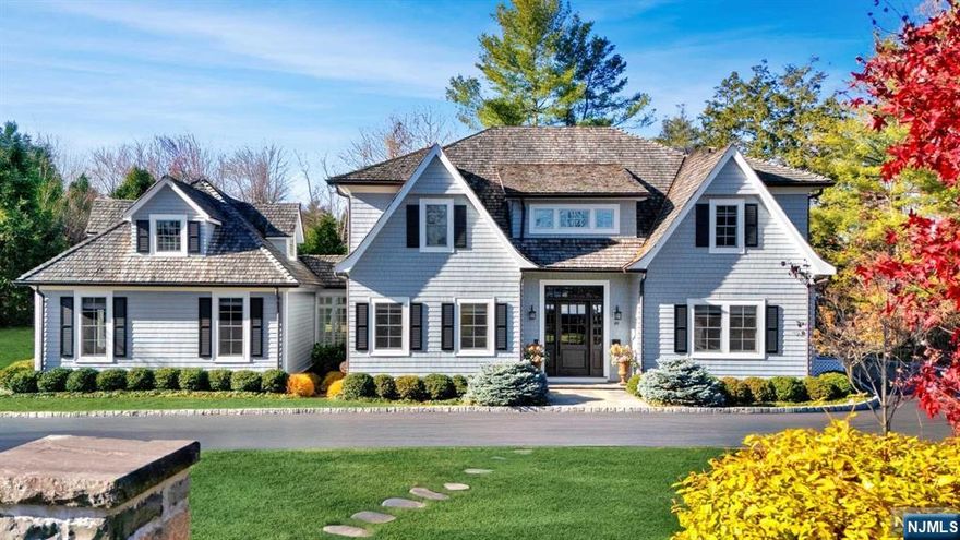 Built in 2017, this upscale home offers luxury and comfort on a flat 2/3-acre lot in Old Short Hills. Designed by architect Tom Baio AIA, its generous windows and French doors flood the home with natural light, while 10-foot ceilings enhance the spacious feel. Interior designer Robin Gannon added bespoke finishes and built-ins, creating unmatched elegance. The gourmet kitchen, with two large islands and top-tier appliances, flows into a fireside family room, ideal for entertaining. The first floor also includes a private office/in-law suite with a separate entrance. Upstairs, the primary suite features a fireplace, custom walk-in closets, and a spa-like bath. Four additional bedrooms and a laundry center complete the second floor. A third-floor loft with a full bath and a finished lower level with high ceilings, a rec room, gym, bedroom suite, and storage provide versatile living spaces. The heated 3-car garage and private backyard with a bluestone patio add to the home's appeal.