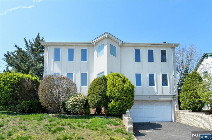 Discover exceptional space, light, and versatility in this oversized home nestled in the heart of Hackensack. A dramatic two-story foyer sets the tone, welcoming you into an elegant formal dining room adorned with a sparkling chandelier, seamlessly flowing into a refined formal living room, perfect for both everyday living and entertaining. The modern eat-in kitchen is thoughtfully designed with stainless steel appliances, abundant cabinetry, and a sunny dining area with direct access to the deck, ideal for indoor-outdoor living. Just beyond, the inviting family room features a cozy wood-burning fireplace, creating the perfect backdrop for gatherings. A powder room and convenient first-floor laundry complete this level. Upstairs, youâ€™ll find three generously sized bedrooms with a Jack-and-Jill bath, along with a serene primary suite featuring a skylight and private en suite bath, your own peaceful retreat. The fully finished basement expands the homeâ€™s versatility, offering a private entrance, full bathroom, two bonus rooms, and direct access to the oversized garage,ideal for extended living, work-from-home space, or recreation. Perfectly positioned near premier shopping, top-rated dining, beautiful parks, and easy, reliable transit into NYC, this home delivers the perfect blend of size, style, and convenience in one exceptional offering. Call us for more info 201-398-9898