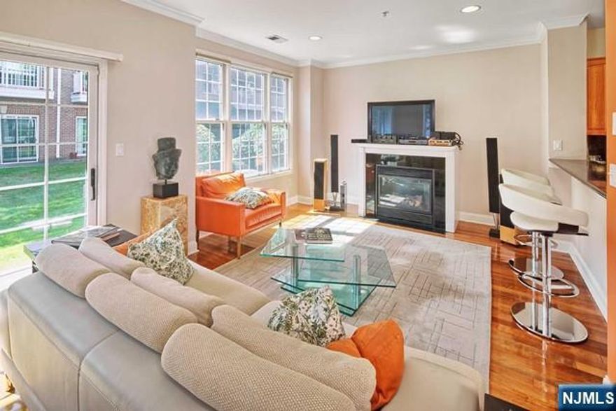 Incredible Bull's Ferry end unit Bergen!! Upgrades galore!! New rich cherry floors!! Gourmet kitchen with solid granite counters and back splash, cherry cabinets and GE Profile stainless steel appliances. Fireplace with marble surround. Designer interior accents; crown moldings, custom painted, custom light fixtures. Wrought iron railings. California closets.Sundrenched all day long. All this with private patio and river view entrance!! Parking for two cars; one in private garage and one in driveway. Community includes two pools with Jacuzzis, child play ground, waterfront promenade and free shuttle to NY Waterway Ferry and Light Rail. Steps to 158 bus to NYC. Close to shopping and restaurants. Do not miss this opportunity!!!!