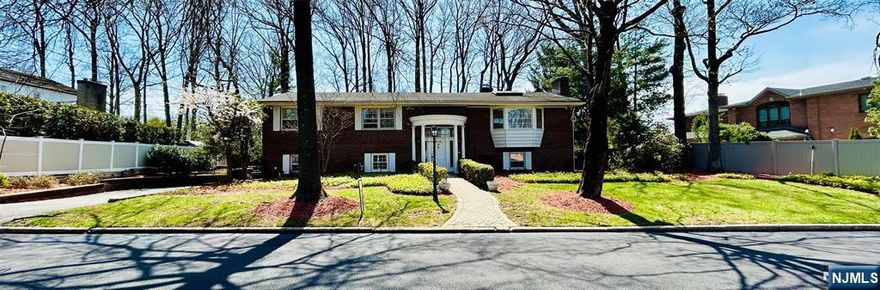 This expansive brick bi-level home situated on a flat 0.28-acre lot, offers immense potential, also for developers, to renovate or to decorate. Upon entering the main level, find a spacious layout that includes a generous sized formal dining room, cozy living room equipped with a fireplace, creating an inviting atmosphere. The eat-in-kitchen has direct access to an expansive deck, perfect for outdoor entertaining. This level also includes a Primary en-suite bedroom, 3 Bedrooms and a full bath offering plenty of space for family and guests. Steps down from the entryway, discover a large finished basement extending living space, recreation & entertainment areas, 5th bedroom, full bath, laundry facilities, separate exterior entrance to office with waiting room, in addition to an oversized two-car garage. This prime location is conveniently close to parks, recreation, shopping, fine dining and entertainment just minutes commute time to NYC. You can own property in the highly desirable Eng.Cliffs North section. Come see it!