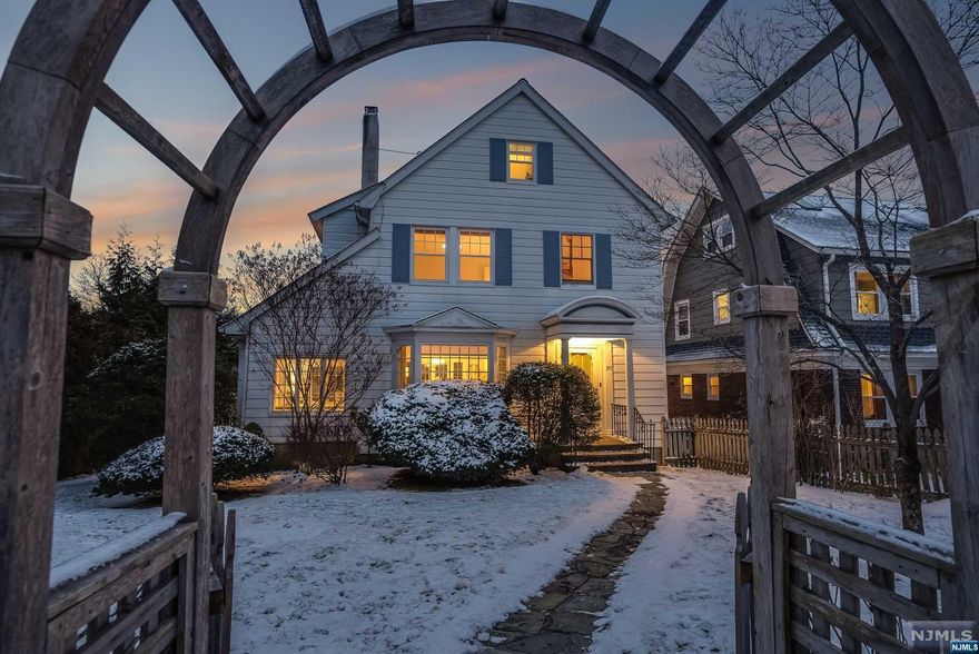 In addition to the perfect location, this updated home has curb appeal and charm! The 1st floor is the heart of the home with easy flow between spaces, sunlight pouring through the many windows and French doors, and pristinely restored details like dentil molding and original built-ins. The Kitchen will delight with an expanse of white quartz counters, SS appliances,center island w/ breakfast bar and easy access to the DR. The two-sided fireplace connects the LR and Den w/original stone floors and door to the garden. French doors lead to the covered porch overlooking the garden, w/ ceiling fans & plenty of space for outdoor entertaining and dining. Upstairs, 3 large BR's & updated Full Bath await.3d floor is a perfect hang-out or 4th BR. The lower level is a walkout, through the built-in garage, with updated Full Bath w/radiant heat and separate Laundry Room.Central air throughout, New Furnace, Roof & H/W Heater within the past 5.5 years. Generac generator. .4 mile to NYC train.