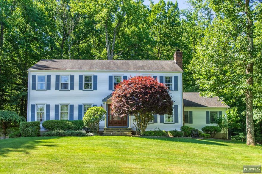 Lovely, Welcoming Colonial in the desirable Robin Hill/Union Hill section of Denville! Private property nestled within a lovely neighborhood. Extremely Well maintained, Original Owners. Warm and cozy Family Room w/ WB fireplace. Large eat-in-kitchen boasts tons of counter space & slider to stunning back deck. Magnificent first floor layout includes Formal Living & Dining. Powder room, laundry & BONUS 5th bedroom w/ suite- second kitchen & full bath. Gorgeous hardwood flooring throughout. Upstairs, the primary Suite offers a walk-in closet, a vanity area & en-suite bath. 3 Additional generous sized bedrooms & the 3rd full bath complete the floor. The spacious basement offers easy access off the 2 car garage and residential chair lift for ease! Nicely landscaped, grassy lawn for enjoyment, plus large deck backing private, wooded oasis. Great yard, low maintenance. A showcase home! Low taxes for size home & over 1 acre of property.