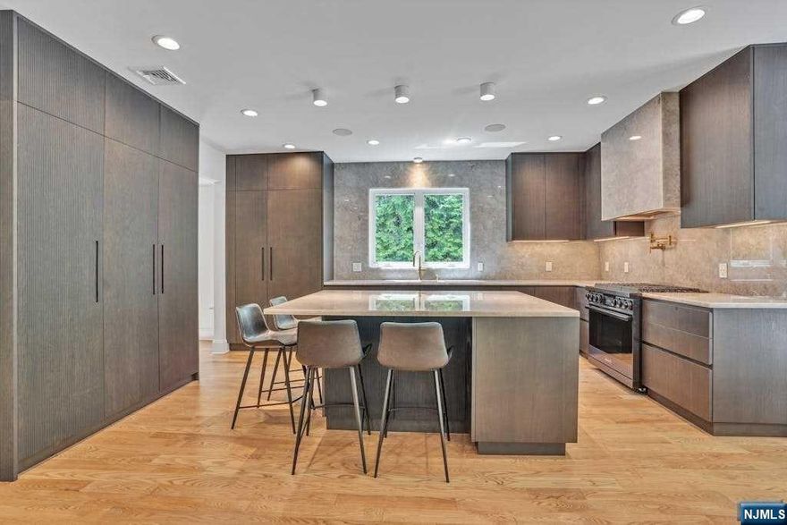 >>Contact listing agent Anat 201.341.4765<< A magnificent 8-year young new construction! This extraordinary home boasts 5 bedrooms and 4.5 bathrooms and is located on a quiet street minutes to three schools. Featuring a fabulous LR, a formal DR, and a brilliantly lit FR with a gas-burning fireplace, seamlessly connected to a THE CHEF'S GRADE BRAND NEW KITCHEN. This Kuche & Cucina kitchen features Dacor appliances and stunning cabinetry. Also, new mudroom! The spacious master suite is a true retreat, with high ceilings, WIC, and a luxurious master bathroom featuring a six-foot free-standing tub, a grand shower, and a double-size vanity. On the 2nd floor are 2 other bedrooms sharing J&J bath and an ensuite bedroom. Complementing the 2nd floor is an office and laundry room The fully finished basement with a full bathroom, a large recreation area, a bedroom large windows and storage complements this gorgeous retreat . The backyard is totally private, surrounded with fully grown t