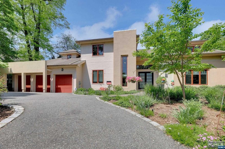 >>>CALL LISTING AGENT ANAT EISENBERG 201.341.4765<<< Tribeca-inspired loft-style design on the E Hill of Tenafly. Situated on over 0.5 acres of private property featuring 5 bedrooms and 4.5 bathrooms (can fit in a pool.) First floor boasts an open layout with 10' ceilings a living. room with a cozy fireplace, a dining room, a family room, a state-of-the-art gourmet kitchen, a center island, a library, a powder room, a mudroom, and a 3-car attached garage. Enjoy a breathtaking view of the stunning backyard, lush landscaping, and paver patio from these rooms. The 2nd floor features a luxurious master suite with a spa-like master bath, Jacuzzi, and a large walk-in closet. An en-suite bedroom, and two additional bedrooms with a J& J bathroom. The walk-out lower level offers a recreation room, a bedroom, a full bath, a laundry room, and ample storage space. Hardwood floors throughout, radiant heat in all bathbathrooms and the lower level. Many recent updates.