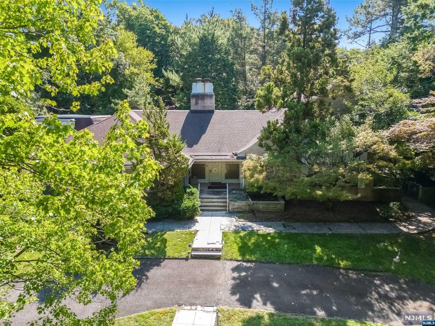 Discover the potential of this expansive 1.4-acre property, perfectly situated for your dream home! Step into the living room, ideal for both intimate gatherings and large celebrations. The adjoining dining room is equally impressive, accommodating sizable get-togethers with ease. For quieter moments, enjoy the cozy bar and library, complete with a fireplace. Nestled in a serene and picturesque setting, this lot offers ample space for custom building, with plenty of room for expansive outdoor living and recreational areas. Enjoy the benefits of a generous lot size that provide privacy and flexibility, while still being conveniently located near essential amenities and services. The land is gently rolling with beautiful natural surroundings, providing a blank canvas for your vision. Premier location provides easy access to Houses of Worship and NYC-the perfect blend of suburban tranquility and urban convenience.