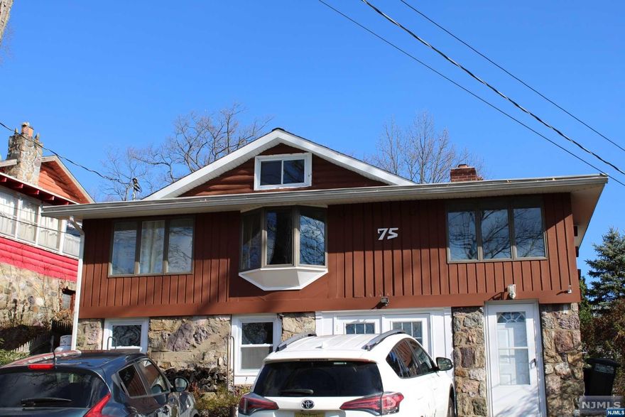 provides a nice view of the lake during the fall and winter. The septic is newer and has been maintained (2012). The back yard is a nice level lot with a large cozy wooden deck to entertain as well as a fenced in yard that provides a sense of privacy and security. The private driveway is nice and wide space allowing for two or more cars comfortably with additional parking directly across the street where additional space is provided for parking. The basement is a partially finished space that is accessible from the driveway through two French doors, this area has some good potential that can be improved upon. There is also storage space as well as a workshop area for those who are industrious. This home is being sold strictly "As Is".