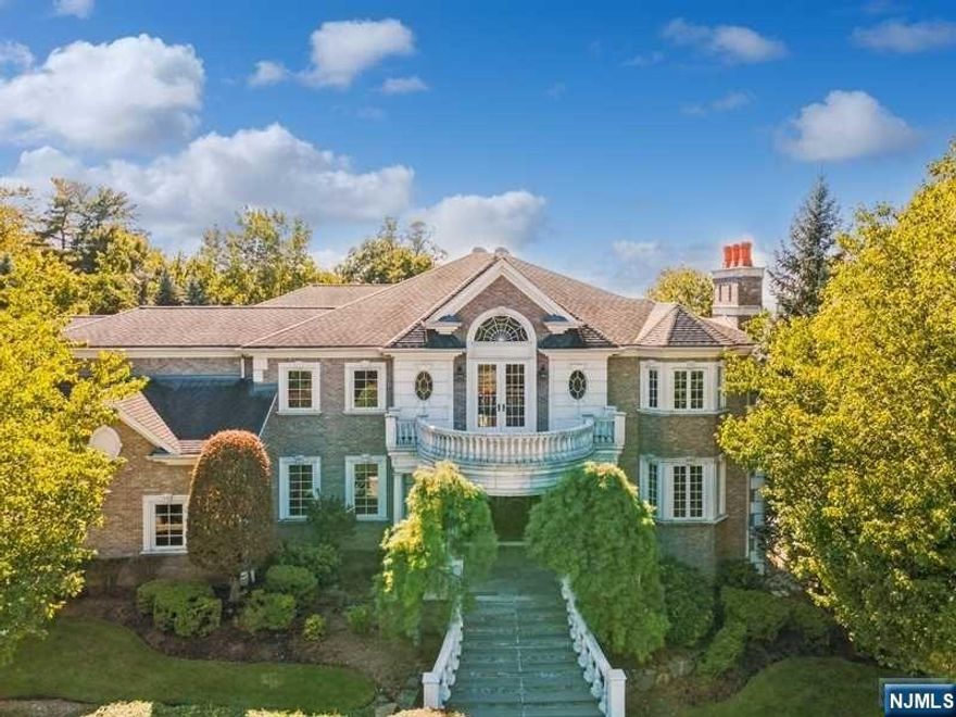 Perched high on a South-facing knoll, this perfect, private all-brick 6 bedroom meticulously maintained family colonial is now available for the first time to be enjoyed by a discerning buyer. Western-valley views can be enjoyed from multiple areas in a sprawling layout. Four generous-sized reception room on the main level include a living room, dining room, great room, library plus a large kitchen/breakfast area and a bedroom. The second floor accessible by both main and rear staircases has a large primary suite and three additional family bedrooms. All rooms have a towering view of either the valley to the West, the South facing swimming pool in the rear yard, or intricate rock cropping at the approach to the home. The lower level is large, with a great entertainment area, a theater room, plus a bedroom and bath. All accessible to a covered rear loggia and yard.