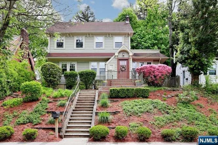 Welcome to 61 Hawthorne Terrace, a timeless 1920s Colonial in Leoniaâ€™s sought-after "Hill" section. This 1,600+ sq. ft. gem blends classic character with modern luxury. A custom front door and updated siding lead to a sun-drenched, front-to-back living room featuring a gas fireplace and restored wood floors. The renovated kitchen is a delight with quartz countertops, custom cabinetry, stainless steel appliances, a large farmerâ€™s sink, and opens to a bright dining room overlooking the front yard. The main level offers a versatile bonus room (bedroom, office, or den) and a full renovated bath. Upstairs, find three bedrooms and a second updated full bath, plus custom closet shelving for peak efficiency. The private, fenced backyard and paver patio offer a secluded sanctuary. Moments from top-rated schools, downtown shopping, and NYC transit, this home offers small-town charm with big-city convenience. Your Leonia story starts here!
