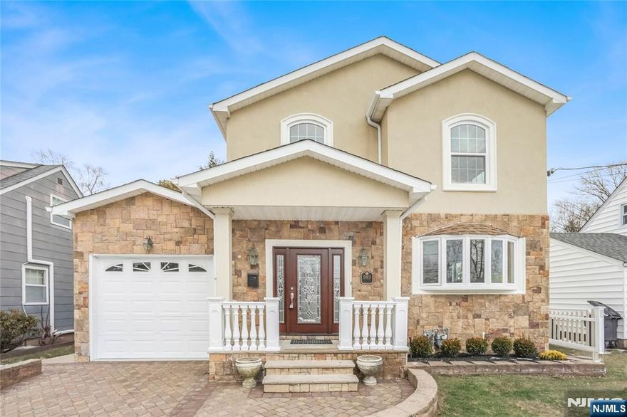 Welcome to this beautifully crafted 4-bedroom, 2.5-bath Colonial on a prestigious block in Clifton, NJ, rebuilt as new construction on the original foundation in 2007 a total of approx 3300sqft of living space and offering a perfect blend of classic elegance and modern comfort. The exterior ft an attractive stucco and stone facade with vinyl siding and oversized windows, gleaming hardwood floors, high ceilings, central air, forced hot air, and energy-efficient solar panels. The 1st floor offers an inviting foyer with 2 coat closets, a home office with bay window, spacious living room, tiled dining room, and an eat-in gourmet kitchen with custom cabinetry, granite countertops, ss appliances, and a large center island, plus 2 French doors leading to a Trex deck ideal for entertaining, a bedroom with two closets, and an elegant powder room. Upstairs ft an expansive primary suite with a huge walk-in closet, private balcony, and luxurious bath with double vanity, Jacuzzi tub, and jetted shower, along with 2 large bedrooms with double closets and a full bath with jetted tub. The full finished basement offers high ceilings and a dedicated laundry room, fully fenced backyard includes a patio, built-in shed, and sprinkler system. Additional highlights include a paver driveway, attached garage, and an unbeatable location minutes to major highways, steps to NYC bus transportation, close to train, shopping, country club, schools, parks, and houses of worship. Truly a must-see home!