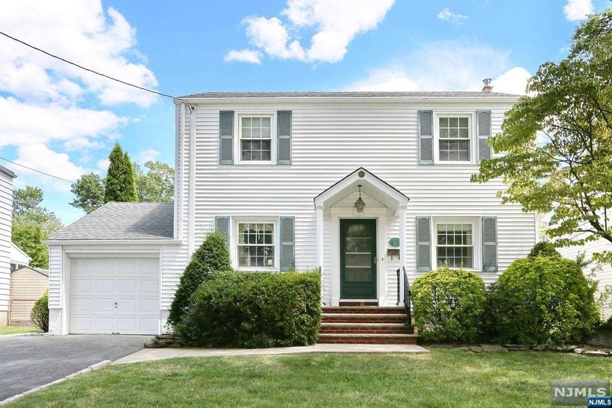 Picture perfect Center Hall Colonial in terrific location! Entry foyer, modern kitchen with peninsula island that opens to dining area, gorgeous living room with built in book cases, family room/dining room addition with full bath and exit to deck. Upstairs three good size bedrooms and full bath. Basement is semi finished. Hardwood floors, gas heat, central air conditioning, whole house back up generator. Private yard, one car garage, double wide driveway. Close to Dumont's Memorial Park, Grant School, local shopping and NY transportation on Washington Avenue.
