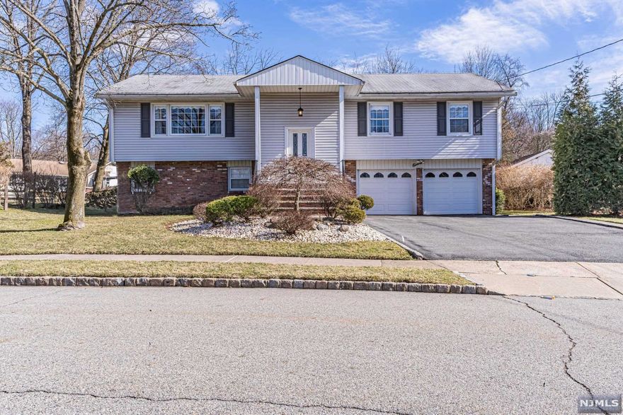Welcome to this lovely, well-maintained Bi-Level in the quiet, Hampton Oaks section of Roseland. Once inside, you are greeted by a large, inviting living room w/a hand-painted wall mural that flows into the formal dining room and EIK that are bursting with natural sunlight. The main floor also features 3 BRs (the Primary BR w/en-suite bath + 2 other BRs), main bath and gleaming Hardwood flooring (even under the carpets!) As you make your way down to the lower level, you will find a 4th BR, w/updated powder room, large Rec Room w/walk-out, a second kitchen w/access to the outside, and a second dining room, along with a storage/laundry room and garage access - a great option for guests or an in-law suite! The spacious backyard is level and fenced in and features a large patio that is perfect for BBQ'g and outside get-togethers in the warmer months. Come visit and make Roseland your new home!