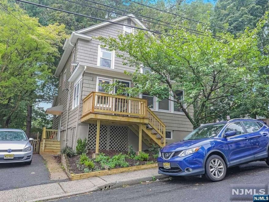 If you love architectural detail and traditional charm, this house could be the one for you. You'll find original chestnut woodwork throughout the first floor and stained glass windows framing the living room fireplace, and the original parquet floors are stunning. From the formal dining room, the French door provides direct access to the fenced-in back yard, which is adjacent to historic Llewelyn Park. From the spacious landing at the front door entrance you can enjoy a view of the the New York City skyline. A sunroom, a light-filled enclosed entry porch, stainless kitchen appliances, a pantry so large you couldn't possibly fill it, and a full bathroom complete the first floor. There are 3 bedrooms and a full bath on the second floor. The large walk-up attic is perfect for expansion of your living space, e.g., a primary bedroom suite, or for continued use as very accessible storage. The partial