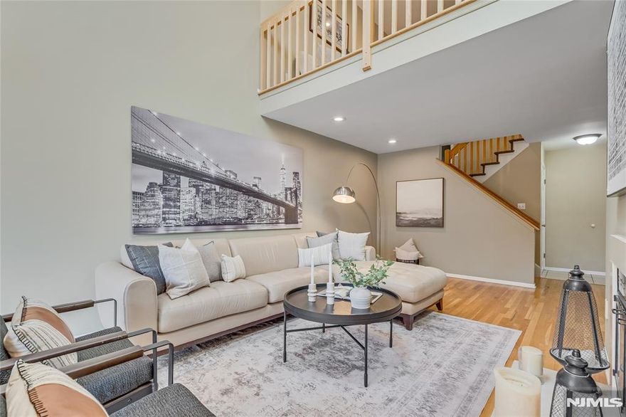 Bright, spacious and beautifully updated Muirfield model in the desirable West Essex Highlands community featuring a first-floor primary suite. The primary retreat offers tray ceilings, a large walk-in closet and an updated spa-like bath, along with access to a recently renovated deck. The eat-in kitchen features stainless steel appliances and granite countertops and flows into the expansive living and dining areas. The living room is anchored by a gas fireplace and sliding doors that open to a second renovated deck surrounded by peaceful wooded views. A newly renovated powder room completes the main level. Upstairs, a spacious loft provides flexible living space and is accompanied by a home office/bedroom and an additional bedroom that shares a generous hall bath. The full basement offers excellent potential for future living space, recreation or storage. Residents enjoy the amenities of West Essex Highlands, including a clubhouse, outdoor pool and tennis courts, all within a beautifully maintained community.