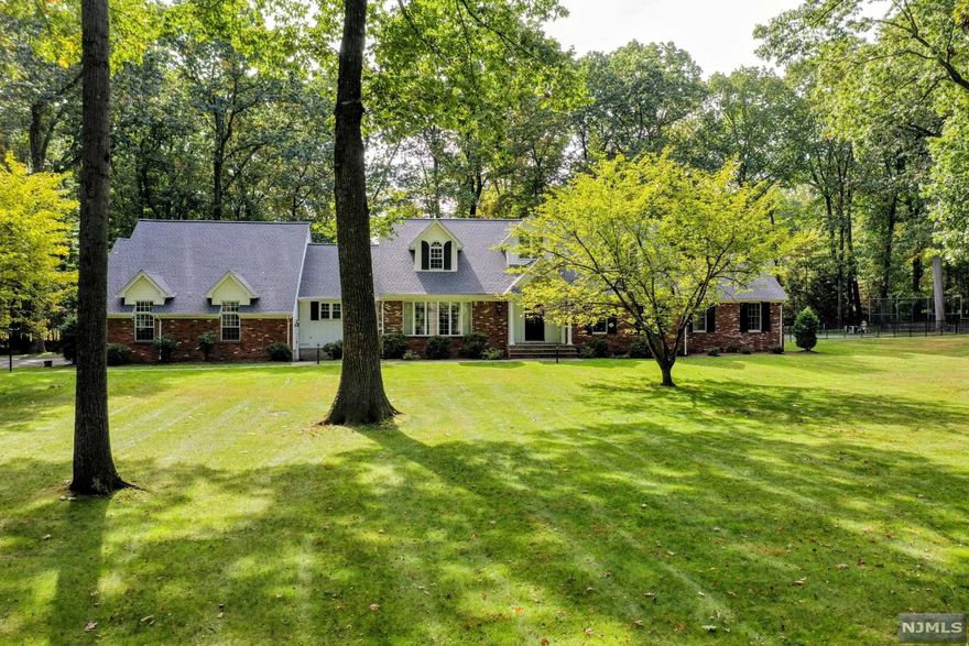 Classic Saddle River home in fantastic neighborhood. This 4 BR, 2 full and 3 half bath home with pool and tennis court offers privacy and large rooms throughout. Elegant foyer leads to a generous living room, a huge dining room for hosting all the holidays, beautiful great room with dual fireplace going into a gorgeous sunroom, large eat-in kitchen and expansive master bedroom suite and laundry room complete the first floor. Three spacious bedrooms, bonus room, full bath and unfinished bonus room complete the second floor. Full finished basement offers a summer kitchen, half bath and separate room. Three car garage, greenhouse, large patio, pool and tennis court offer resort living in your own backyard. This could be your new "Home for the Holidays!"!