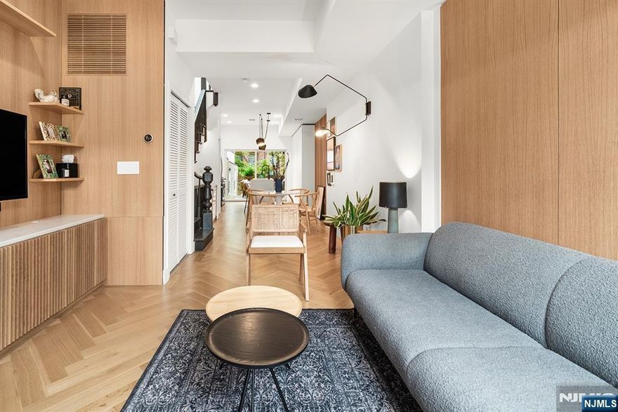 One of Kind-Dazzling Designer 4 Bedroom 3 Bath newer custom (2021) home meets Urban Luxury Living. With coveted outdoor living spaces to enjoy. Experience the beauty. Step inside this Modern home boasting a Movie set quality. Dripping in high end, custom finishes; abundant millwork from lavish white oak chevron flooring to Gallery paneled walls. One can't help but notice the dangling Flos light fixtures & exposed brick walls that will leave you Marveling! The home embraces the way we like to live now with Smart features; Lutron;shades, lighting+outlets; virtual security. The Chef's Kitchen is a Dream...outfitted w/ contemporary sleek 2 tone cabinetry, a concealed espresso station & bottle rack. A Calcutta Marble dining peninsula w/ waterfall edge & counters pair w/ SS appliances; a gas vented oven range. Perfect for entertaining, indoors or out. Travel upstairs to soaring 10ft ceilings, 2 Bedrooms. The Primary features ensuite luxury bath, walk-in closet, custom closets! An eye catching, vibrant green gallery accent wall. On Level 1- find 2 Bedrooms, a luxury full bath. Electrolux W/D. Seamless access to outdoor retreat w/ blue stone, turf grass, lounge area & fire pit. Notable: whole house water filtration; Central HVAC: A Burgeoning McGinley square location surrounded by convenience & new developments. Hassle free commuter options to NYC are steps away; NJ Transit Bus or Path Train @Journal sq. Contact text Angela Cuciniello for details 201 657-6084. Don't Miss Out!