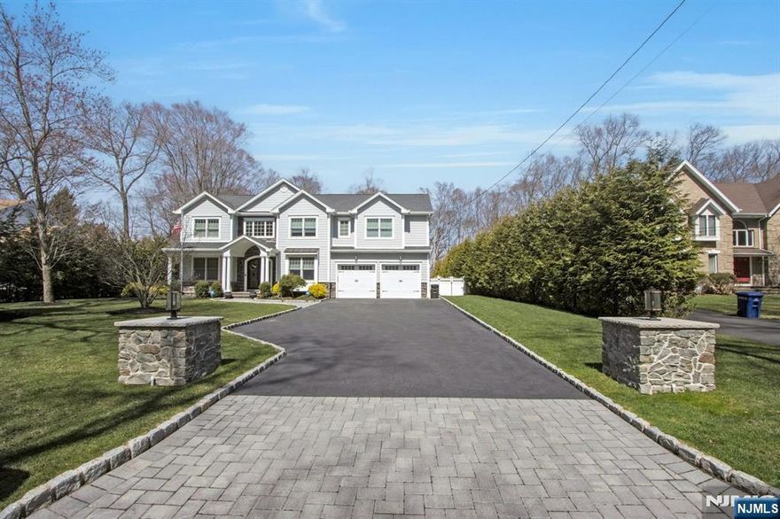 Welcome to your dream home in River Vale! This luxurious Center Hall Colonial features a resort-style backyard perfect for entertaining or relaxing. Step into a stunning two-story foyer with a grand staircase. The formal living room offers a coffered ceiling, and the great room features a custom fireplace and wall of windows overlooking the lush backyard. The sleek kitchen includes white cabinetry, Quartz countertops, a large island, high-end appliances, and a pantry. A butlerâ€™s pantry connects to the banquet-sized dining room with tray ceiling. A mudroom with custom built-ins and a half bath complete the main level. Upstairs, the primary suite offers dual closets and a spa-like bath with double vanity, oversized shower, and soaking tub. Two junior suites, two more bedrooms (one with Jack-and-Jill access), and laundry complete this level. The lower level features a rec room, bonus space, and half bath. Outside: heated saltwater pool, patio, fire pit, cabana with summer kitchen and bar.