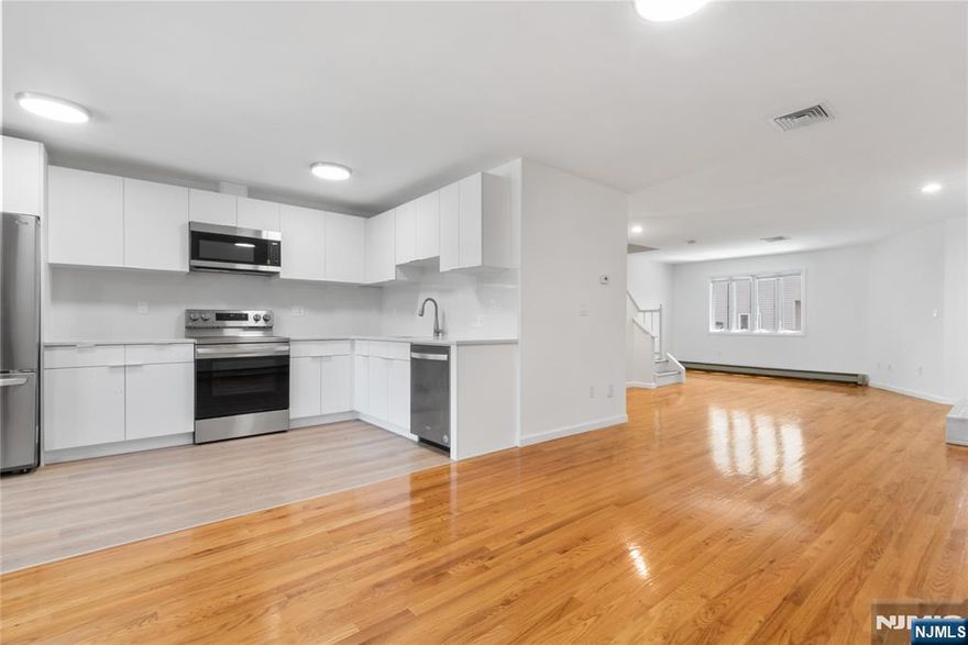 Well-maintained and spacious 3-level 2300SF townhouse offering 3 bedrooms and 3.5 bathrooms in a quiet residential neighborhood. Freshly painted with hardwood floors throughout. The main level includes a bright living room with fireplace, dining area, and a brand new kitchen with stainless steel refrigerator, stove, and dishwasher. The second floor offers a primary suite with vaulted ceilings, two closets, and a private bath, along with an additional bedroom and full bath. Convenient second-floor laundry and ample closet space. The lower level includes a third bedroom or den with full bath, interior access to the one-car attached garage. Additional features include central A/C, baseboard heating, central vacuum system, skylights, and a private balcony. Located on a dead-end street close to center of town, schools, NYC transportation, shopping, restaurants, houses of worship, and major highways.