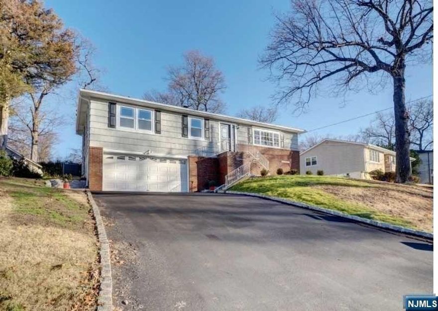 Lovely renovated Raised Ranch in West Caldwell. This sophisticated home features a spacious living room with hardwood flooring and abundant natural light. The dining area seamlessly transitions to a newly renovated kitchen with quartz countertops, soft white cabinetry, and stainless-steel appliances. Sliding doors from the kitchen lead to a large private yard with a paved patio, ideal for entertaining, relaxing, or enjoying outdoor activities. The one-floor living space offers three bedrooms, one with a private full bath, another two spacious bedrooms. Additional amenities include central/hot forced air, a fully finished basement with a laundry room, family room, den/office, and a half bath. The property includes a two-car attached garage and a driveway for four more vehicles. Conveniently located near parks, restaurants, public transportation, major highways, and convenient NYC commute. To preview this property, Call Sao Gutierrez at 973-207-0956