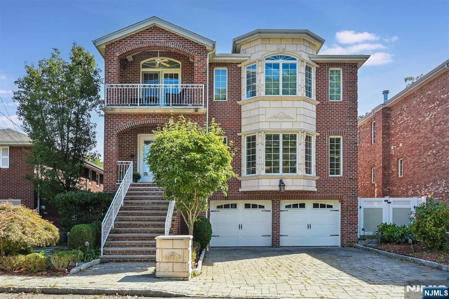 You'll be impressed by this stunning, newer, all brick colonial by a premier local builder. Exceptionally maintained inside and out, this home features luxurious finishes, custom millwork, hardwood floors throughout, and radiant heat under all tiled floors. The light-filled grand entrance hall opens to an elegant living room and a formal dining room that leads to an inviting family room with a wood burning fireplace. The gourmet kitchen has custom cabinets, a center island, high-end stainless steel appliances and a powder room. The deck off the kitchen completes the first floor. The primary suite features tray ceilings, double closets, and a spa-like primary bath with whirlpool tub, double vanity and steam shower with 9 shower heads. There are another 3 additional generously sized bedrooms with two full baths. The ground floor features a rec room with a gas fireplace, bar and access to the yard and pool. Private backyard with heated in-ground pool with whirlpool, patio with outdoor speakers. Within minutes to NYC.