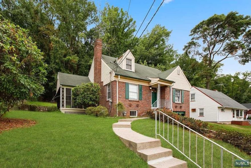 This original red brick Cape sits on a quiet street. The blank canvas offers tons of possibilities for your inspired decorating dreams. The hard wood floor, build-in cabinets and wood burning fireplace place will warm your toes and your heart. This comfortable 4 bedroom is filled with natural light. Sit and relax in the all-season sun porch. A perfect COVID workspace. Check out the finished recreation room with wet bar, laundry room and access to garage on the lower level. Want more options look no further then the spacious back yard. That is walking distance from High Mountain Park. Conveniently located near NYC transportation, shopping and jersey shore beaches.