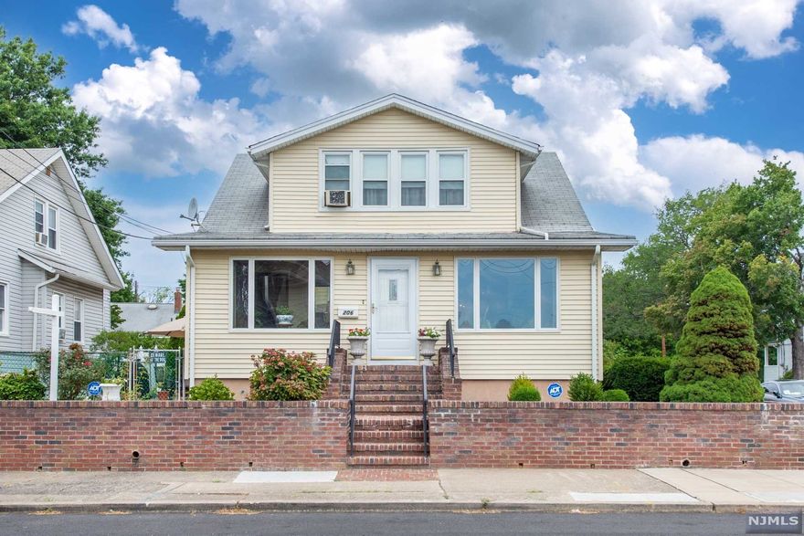 A stunning classic, perfectly preserved in peaceful neighborhood! 3 bed, 2.5 bath beauty pays homage to past generations. Front door opens to breezy lounge area in the front foyer. Huge windows let in desirable natural light and peek-in cut-outs into the living room. Polished original floors throughout, decadent living room with showstopping intrinsic ceiling offers a serene space by the brick fireplace. Formal dining room and golden chandelier with built-in wine storage are perfect for entertaining. Spacious eat-in kitchen overlooks backyard with plenty of cabinets. Ample closet space awaits you upstairs in 3 spacious bedrooms with large closets. Finished basement boasts a summer kitchen, full bath, and family room, perfect for additional space and guests! A quaint backyard is perfect to soak in the sun. Extra-long driveway leads to large 2-car garage! Steps away from NY transit, major highways, and great schools, this meticulous blast-from-the-past can be yours!