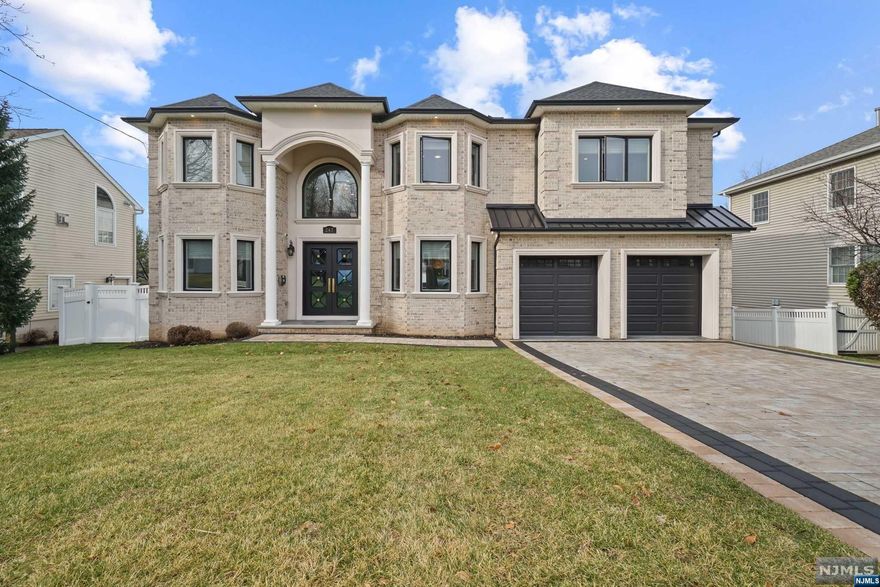 Welcome to exquisite home featuring approx. 6500 sq ft of Modern & Luxurious design on a quiet street. This stunning home is less than 2 years old and installed TESLA solar roof & battery pack, TESLA LV2 Charger, and security cameras to cover the premises. 1st FL- Open 2 story foyer w/ heated marble floor leading to living rm and formal dining rm w/ custom trims works and luxurious wallpaper. Butler's pantry and dream kitchen w/enormous island with BKFST bar, high-end appliances, walk-in pantry, and wet bar. 2 story open space family rm w/ fireplace offers full of sun lights, elegant powder rm, bedroom w/full BTH & mudroom. 2nd FL- master suite w/2 WICs and spa BTH w/ walk-in shower, large soaking tub, and heated floor. A Jr suite w/full bath, 2 more bedrooms, full BTH, and LDRY room. Fully finished BSMT- home theater, rec room, wet bar, bedroom & full BTH. 9 ft ceilings on all FL, 4 zone heat/AC, central vac, sprinklers, and fenced yard. Close to schools, parks, and NYC transit.