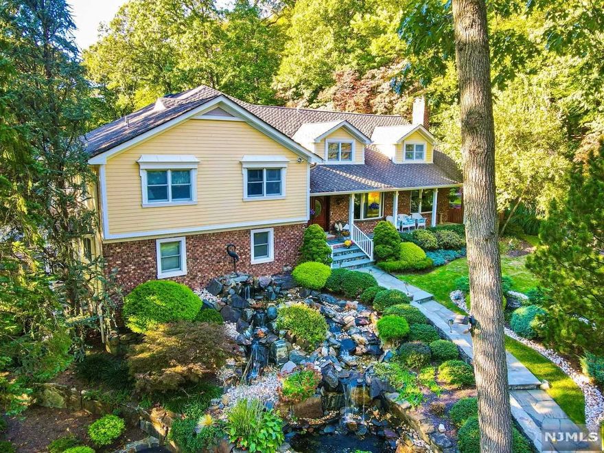 Privately nestled in the woods, this architecturally and recently renovated home is designed to offer the atmosphere of a New England estate while offering the proximity of an easy NYC commute. For extended families, this design allows for multigenerational living. Surrounded by the hiking trails of Pyramid Mountain and many activities of Lake Valhalla, this house sports two gourmet kitchens with Miele appliances, a house elevator making accessibility to this sprawling colonial easier than taking the stairs. 5 beds/4.5 baths; Huge Master suite, professional office with separate entrance, Second enlarged suite, 3 more beds, cathedral ceilings, two wood burning fireplaces, 3 car garage, Landscaped water features and room to build pool. Come see this unique property.