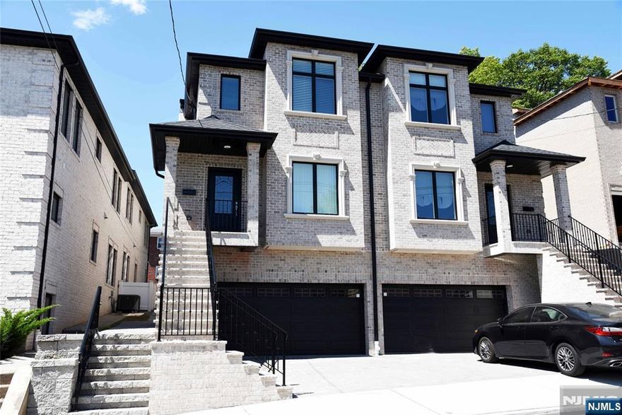 YOUNG BRICK DUPLEX. ALL HARDWOOD FLOOR THROUGH OUT, QUALITY MATERIAL USED, CHEF'S GOURMET OPEN KITCHEN WITH CUSTOM MADE CABINETS, GRANITE COUNTER TOP AND CUSTOM BATHS WITH MARBLE TALES, FIRE PLACE IN THE SPECIOUS LIVING ROOM, SLIDING DOOR TO THE DECK, 3BR ON THE 2ND FLOOR WHICH DOES INCLUDE A MASTER SUITE AND MASTER BATH. LAUNDRY IN UNIT. FULL FINISHED(1BR W/FULL BATH) GROUND FLOOR WITH SEPARATE ENTRANCE, WALKING DISTANCE TO SHOPPING AND NYC BUS. 2 CAR GARAGE