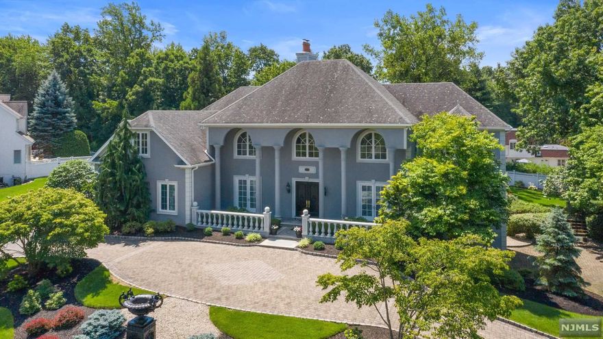 Hunter Ridge, spectacular 5-bedroom ,5 full bath and 3 half bath custom built colonial manor. Situated on a private, landscaped 0.7 acre property on the highest point in Bergen County. This truly exceptional home is synthesis of modern luxury and architectural sophistication, classic elegance, all with a wonderfully comfortable ambiance. Set in prime Bergen County neighborhood, its captivating curb appeal is accented by stunning millwork thoughtful details where natural light floods the home on every level. Grand sized two story great room with fireplace and wall of windows overlooking meticulously groomed and private grounds. Cherry wood library, kitchen with center island and breakfast room. The lower level is complete with large recreation room, GYM, an office with outside entry, a 5 car garage, a walk-in vault and in-law suite, Circular driveway, natural gas generator and more...