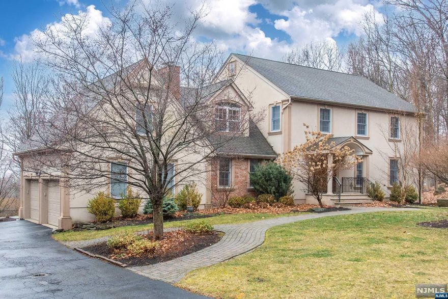 Stunning custom colonial in one of Wayne's most prestigious neighborhoods Indian Hills. Situated at the end of the private cul de sac, this home has an acre of lush grounds, heated saltwater pool with 2 waterfalls, large deck, paver patio and breathtaking views. This home is an entertainer's dream starting with an oversized kitchen situated around an an island, bar/pantry area, newer SS appliances, eat in kitchen big enough for formal dining room table and lots of natural light overlooking the private yard. Formal living, dining and family room with wood burning fireplace, 2 powder rooms, mud room and laundry room complete the first floor. Luxurious large primary suite w WIC and full bath, 4 more bedrooms and another bath on 2nd floor. Full finished walkout basement with powder room, wet bar and bonus room. New HVAC. Convenient location, close to schools, shopping, restaurants and highways. Buses/trains to NYC 27 miles and less then 40 minutes drive. Take a stroll to Pines Lake.