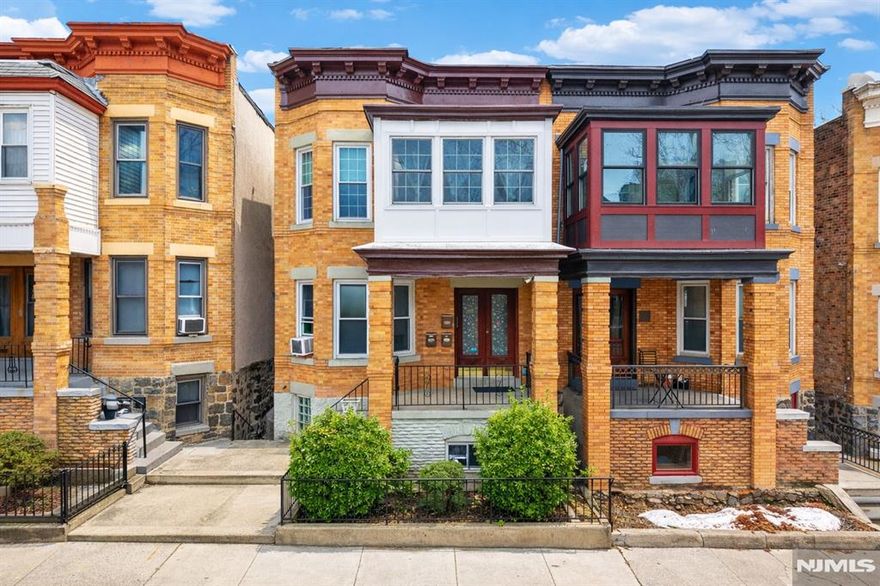 Solid brownstone brick two-family home in Jersey City Heights (07306), near Kennedy Blvd, Christ Hospital, Central Ave shopping, and minutes from Journal Square, Downtown Jersey City, and Hoboken. This well-maintained income-producing property features two spacious units: Unit 1 offers 2 bedrooms and 1 bath, while Unit 2 includes 3 bedrooms, 1 bath, and a bright sun/flex room ideal for relaxing, home office, or playroom. Unit 2 also features a skylight bringing natural light to the hallway and a private spiral staircase with direct access to the backyard, parking area, and finished basement. Each unit includes its own laundry. Finished basement includes a full bath, open space, and additional rooms suitable for various permitted uses. Updated approx. six years ago including kitchens with granite & quartz countertops, windows, walls, and roof. Features include split-wall cooling and Whirlpool appliances in Unit 2, baseboard heating, gated roof-covered two-car rear parking, and private backyard. Excellent commuter location near Journal Square PATH with direct NYC access, NJ Transit buses 84, 86, 119 & 123, and Light Rail connections. Close to Route 139, I-78, NJ Turnpike, Holland Tunnel, and Newark Airport. Near Pershing Field Park, Riverview-Fisk Park, shopping, dining, Christ Hospital, and local amenities. Nearby educational institutions include Jonathan W. Wakeman Elementary School and New Jersey City University.