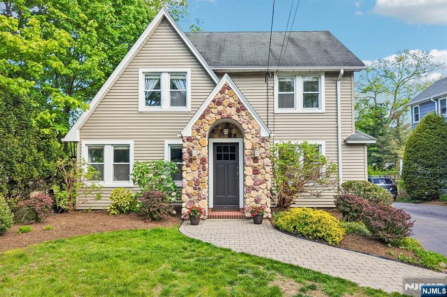 Welcome to this picture-perfect Tudor, where timeless character & everyday comfort come together for unbeatable lifestyle. This 4 bedroom, 2.5 bath home offers a warm & inviting layout, beginning with a gracious living room with fireplace rich in architectural detail & a separate family room designed for relaxed living. The heart of the home, the eat-in kitchen with 6-burner stove offers easy flow to the dining room & access to the mudroom, convenient 1st floor laundry, bedroom and full bath. The 2nd floor offers three well-proportioned bedrooms including a large primary bedroom & a junior suite with half bath. A large walk-up attic & unfinished basement provide valuable additional space. The gorgeous backyard with paver patio is perfect for outdoor dining or a quiet retreat. Complete with a two-car garage & a beautifully manicured setting, this home is a rare opportunity to enjoy classic Tudor charm with versatile spaces, close to Orchard school, parks & downtown Ridgewood