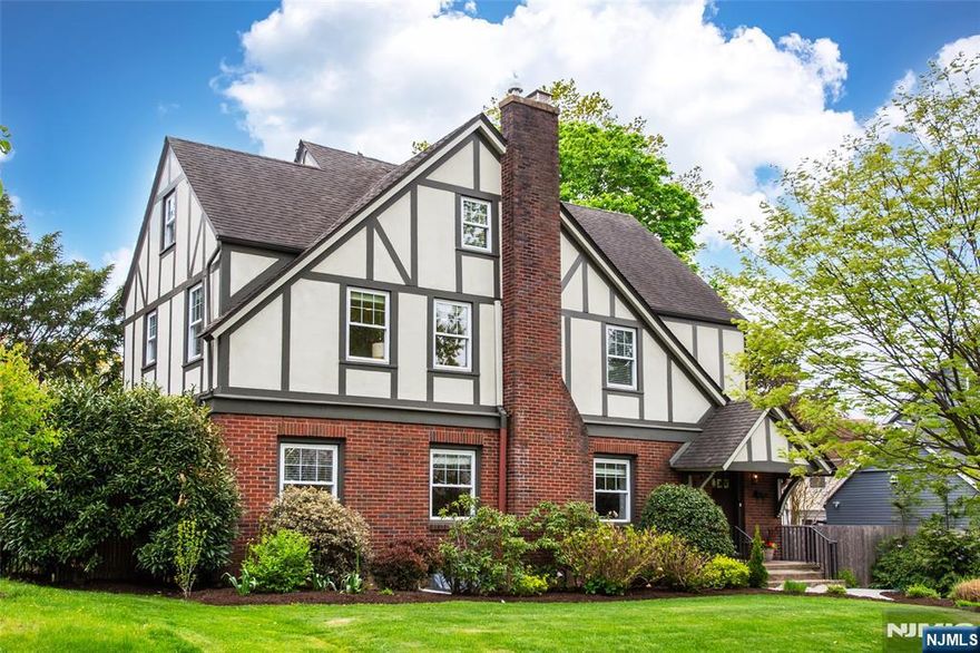Impeccably maintained and thoughtfully updated, this substantial Craftsman Colonial offers the perfect blend of space, function, and location just moments from downtown Montclair and Bay Street Station. Generously sized rooms and an effortless first-floor flow make everyday living and entertaining a breeze. The oversized kitchen is a true standout, featuring a six-burner stove and expansive center island ideal for both casual meals, serious cooking and entertaining. A large living room and bright sunroom complete the inviting main level.Upstairs, the second floor boasts three light-filled bedrooms, a hall bathroom plus an impressive primary suite with an ensuite five-fixture bathroom and ample closets and built-ins for storing your year round wardrobe. Quarter and rift-sawn white oak floors and a two-story library nook add both character and charm. The third floor offers two additional bedrooms and a full bath perfect for guests or work-from-home suite.The finished basement provides flexible space for a game room, gym, or media area. Smart upgrades including a high-efficiency boiler, solar panels, and Tesla Powerwall help keep utility costs very low, year-round. Move right in and enjoy easy living in one of Montclair's most convenient locations.
