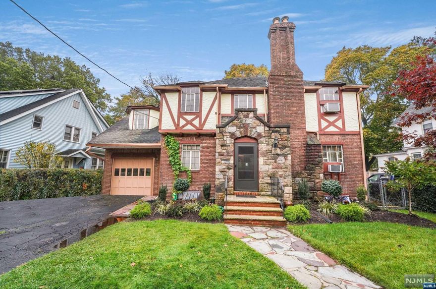 Welcome to this rare and enchanting English Tudor home in Englewood! Boasting an impressive 3,000 square feet of living space, this 4-bedroom gem is a true find. The main level features a spacious living room with fireplace, a formal dining room for elegant gatherings with access to backyard deck, kitchen and a charming breakfast nook for cozy mornings. For family time and entertainment, the finished walkout basement is ideal. The primary suite is a dream with ample closet space and a balcony that offers serene views of the beautiful private backyard. All the bedrooms are generously sized with gleaming hardwood floors throughout, adding warmth and character. A cedar closet provides ample storage for clothing and belongings. This home is a must-see, conveniently located near Englewood's shopping areas and just minutes away from the GWB/NYC. Don't miss out on the opportunity to make this unique Tudor your new home!