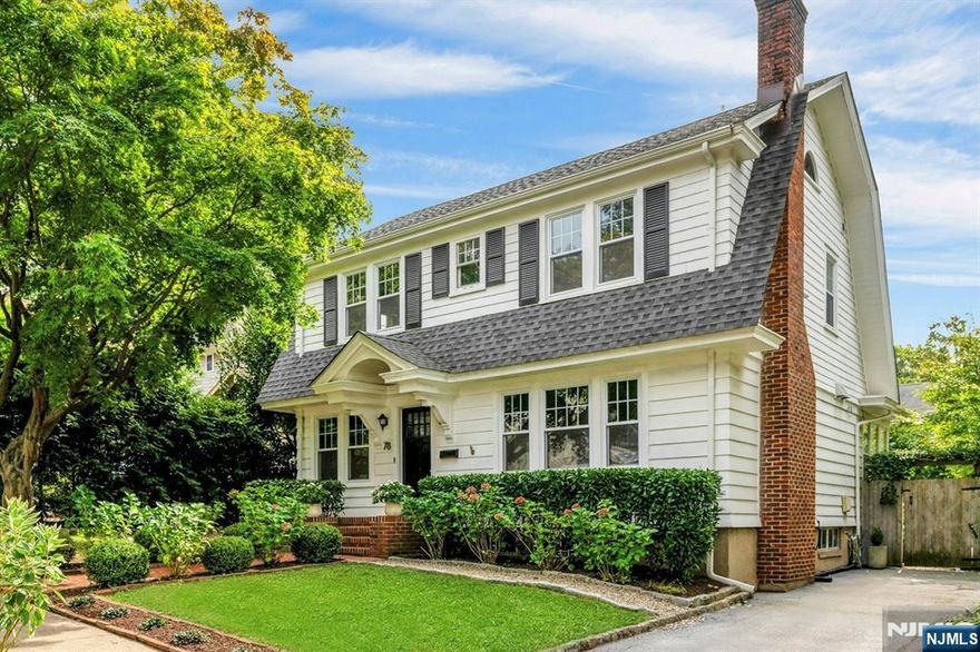 Minutes from South Orange's vibrant downtown, this exceptional home is a rare blend of sophistication, comfort, and convenience. Designed with meticulous attention to detail, it features custom millwork, designer lighting, Waterworks fixtures and refinished hardwood floors throughout. Modern upgrades include a Bose indoor/outdoor sound system and an EV charging station. Inside, you are greeted by thoughtfully curated rooms; a charming sitting room opens into a spacious fireside living room and a sunlit dining room. The fully renovated chef's kitchen showcases Portuguese marble counters and professional-grade appliances including a Bertazzoni refrigerator, Superiore range and Bosch dishwasher. French doors open to a sunroom finished with Hermes wallpaper and Italian marble floors, which leads to a private outdoor retreat with a large deck and gardens filled with hydrangeas, roses, and boxwoods. Upstairs, three bedrooms and a beautifully renovated full bath offer comfort and style, while the primary suite includes a vanity room for added convenience. The lower level includes a powder room and laundry. Perfectly situated near restaurants, parks, and direct trains to NYC, this home is the ideal balance of tranquil living and urban accessibility.