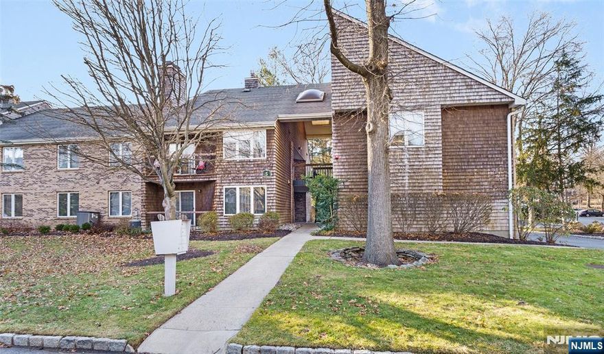 Set within the Tulip Gardens community, this first-floor condo offers a fully updated interior paired with a comfortable layout designed for everyday living. The renovated kitchen features granite countertops, rich cabinetry, stainless steel appliances, and generous prep and storage space, flowing seamlessly into the dining and living areas. Wide-plank flooring throughout enhances the clean, modern aesthetic. The living room is bright and inviting, offering ample space for both relaxing and entertaining, with direct access to a covered porch that extends the living space outdoors. The spacious primary bedroom includes a large walk-in closet and a private en-suite bathroom. Both bathrooms have been thoughtfully updated with contemporary finishes, including sleek floating vanities, modern fixtures, and refined tilework. Recessed lighting and neutral finishes throughout contribute to the home's move-in-ready appeal. Ideally positioned just steps from the NYC bus at the town center, with easy access to the train station and only minutes from Montclair and Upper Montclair's dining and shopping destinations.