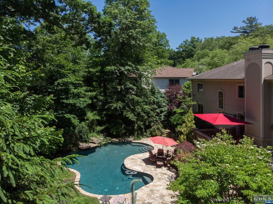 Elegance in the heart of Tenafly! Featuring 7 bedrooms and 6.5 baths, this palatial property will impress even the most discerning buyer. First floor offers a bright, grand entry foyer, gorgeous living and family room flow into a walk-out patio and a handsome dining room perfect for entertaining. Eat-in kitchen boasting butler's pantry with top tier appliances and features to match. Luxury extends to the second level, featuring beautiful and bright bedrooms with bathrooms and enviable closets in each! Enjoy a true master suite with sitting area- even a gym. Fully finished basement boasts rec room, two bedrooms, and full bathroom ideal for guests and even a wine cellar. Outdoor amenities do not disappoint. Enjoy incredible spa-like salt pool with waterfall, stunning deck with grill and additional features for ambiance like recessed lighting, making summer days outside both relaxing and elegant. A top-tier location, close to NYC transportation and more - a true must see!