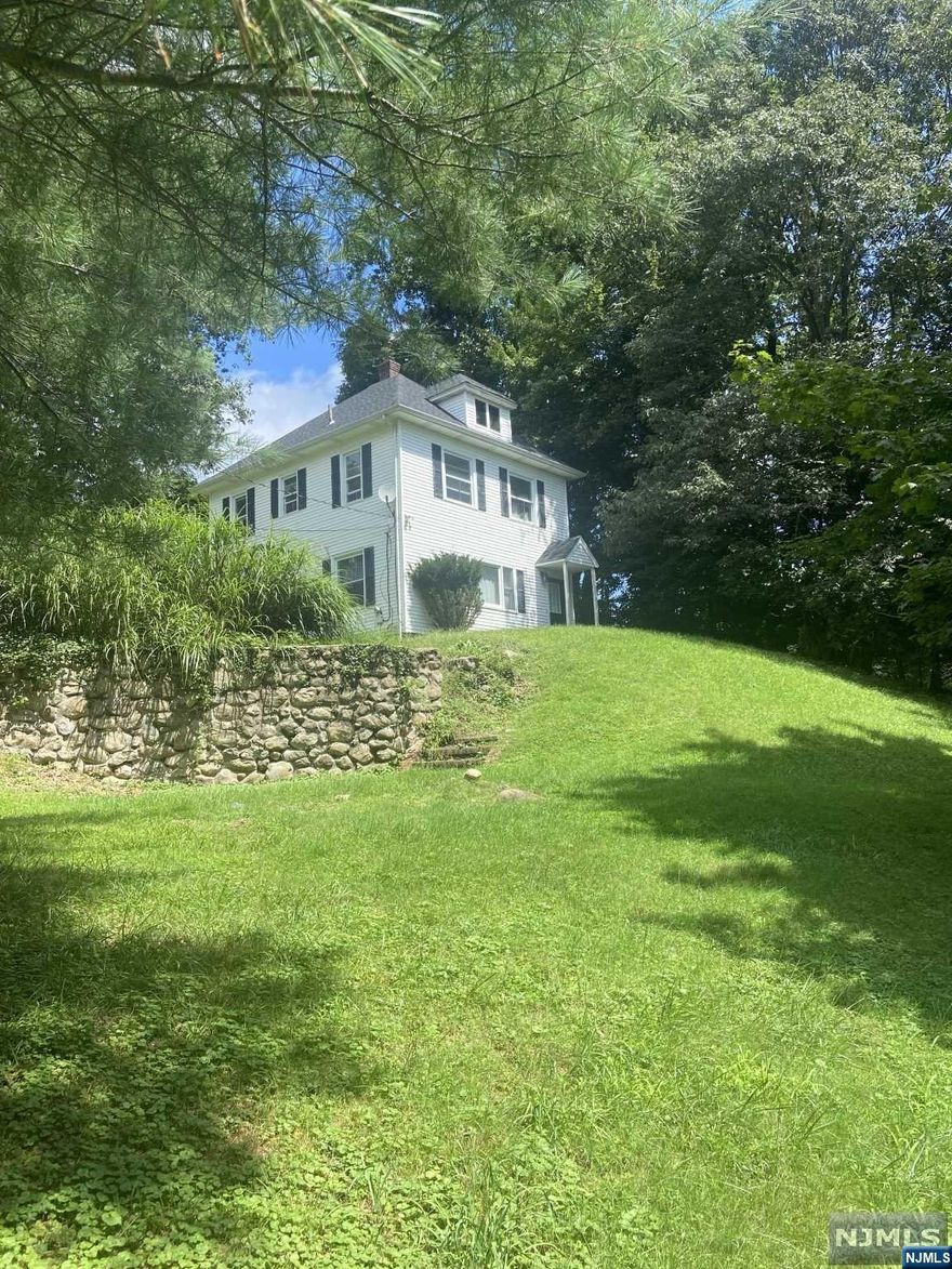 Tucked away and sitting atop a beautiful park-like, 1+acre of property sits a turn-of-the-century side hall colonial. The home offers a truly unique kitchen complete with an old-world charm stove! A charming dining room, living room, 1/2 bath and laundry complete the first floor. Four bedrooms and a full bath complete the upstairs. Additionally, the unfinished stand-up attic offers an opportunity to complete for extra living space. The property is stunning, private, and offers many opportunities such as renovating the existing home, or build new. There's tremendous value in the land!