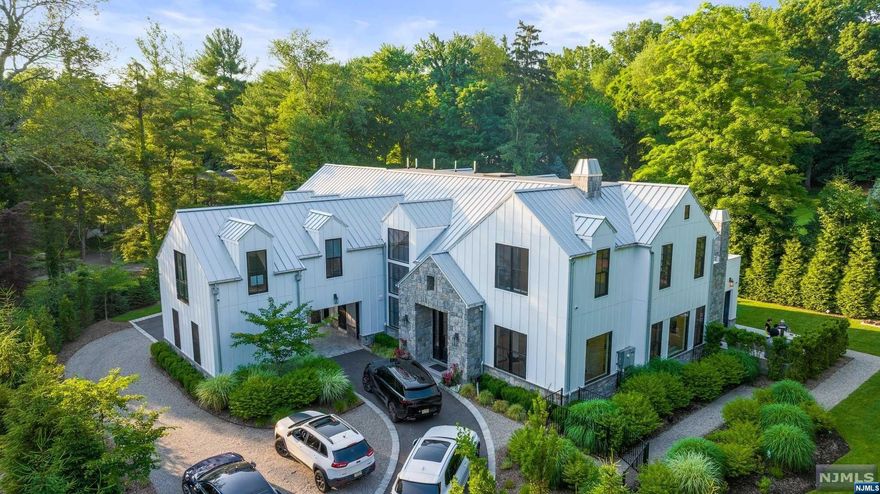Welcome to a custom-built luxury home in the heart of Demarest,This approximate 10,000 sqft residence,inclusive of the basement,offers a modern design with 10-12ft ceilings on the 1st and 2nd floors,perfect for a family that loves to host.Upon entry,you'll be greeted by a grand 2-story foyer and a stunning glass wine fridge!The custom eat-in kitchen is a chef's dream, featuring marble countertops,waterfall island,top-tier appliances. This culinary haven seamlessly opens to an extensive family room and dining area, complemented by an exquisite indoor/outdoor living space.The first floor also includes a powder room and an office with a full bath, adding convenience and flexibility.Upstairs,expansive primary bedroom suite boasts his-and-hers closets, a spa-like bath,a cozy sitting room.Three additional en-suite bedrooms with walk-in closets and a living room space complete this level.The basement features a beautiful recreation area,nanny quarter,theater rm,gym/play rm,a full bathrm!
