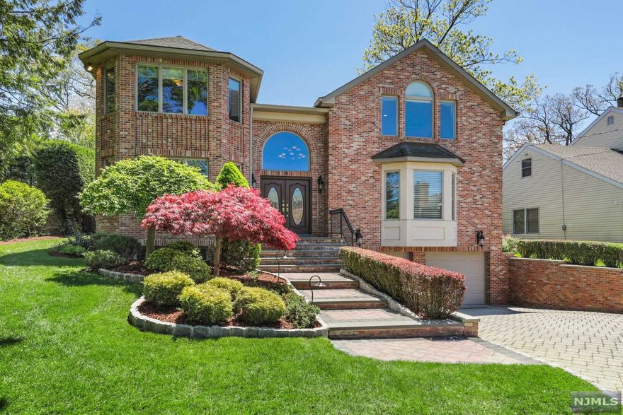 LOW TAXES - Young Brick Colonial located in the prestigious North Cliffs steps from NYC transportation. This 5 Bedroom, 4.5 Bath home was built in 2003 boasting large bright rooms, high ceilings, hardwood floors and quality finishes. The Main Level features a two story marble Entrance Foyer, Living Room, Dining Room, Gourmet Kitchen that opens to a large Family Room with fireplace, Office, Powder Room and Laundry Room. The Gourmet Kitchen features high end appliances, granite countertops, a large breakfast area, walk-in pantry and an exit to the private rear patio and yard. The Second Level is comprised of 4 Bedrooms and 3 Baths including a Primary Suite with a well-appointed Primary Bathroom and 2 walk-in closets. The Lower Level is finished with windows and high ceilings and includes a large Recreation Room with wet bar and refrigerator, Bedroom, Bathroom and exit to a tiled and heated 2 Car Garage. Generator, Alarm, 7 zones Heat (2017), 3 zones A/C, sprinklers, and more!