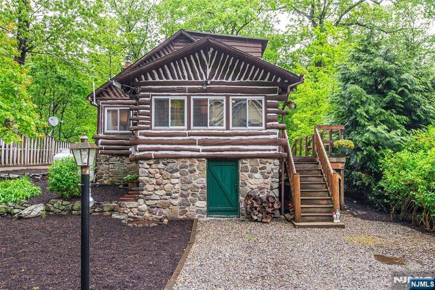 Welcome to this charming log cabin retreat nestled scenic in the Lakeside Community Club of Greenwood Lake! Escape to this cozy 2-bedroom log cabin with a bonus sunroom! This beautifully updated home features a stunning stone fireplace, perfect for relaxing evenings. The spacious wrap-around deck offers outdoor living at its best. Inside, enjoy an upgraded kitchen (2024) with butcher block countertops, soft-close drawers, a dishwasher, and in-unit laundry. Hardwood Floors! Modern updates include a newer 200 amp electric panel, water heater, and forced air system with heat pump for year-round comfort. Whether you're looking for a weekend escape or full-time living, this cabin combines rustic charm with modern conveniences. Near hiking trails! Optional membership to Lakeside Community Club; includes optional boat slip at clubhouse, Private Beach, Basketball hoop, kayak storage and a clubhouse that can be rented out. Clubhouse is complete with fireplace and bar and has lake views and access! Vacation from home everyday! Don't miss this serene getaway schedule a showing today! *Driveway and parking on Terra Cotta Rd