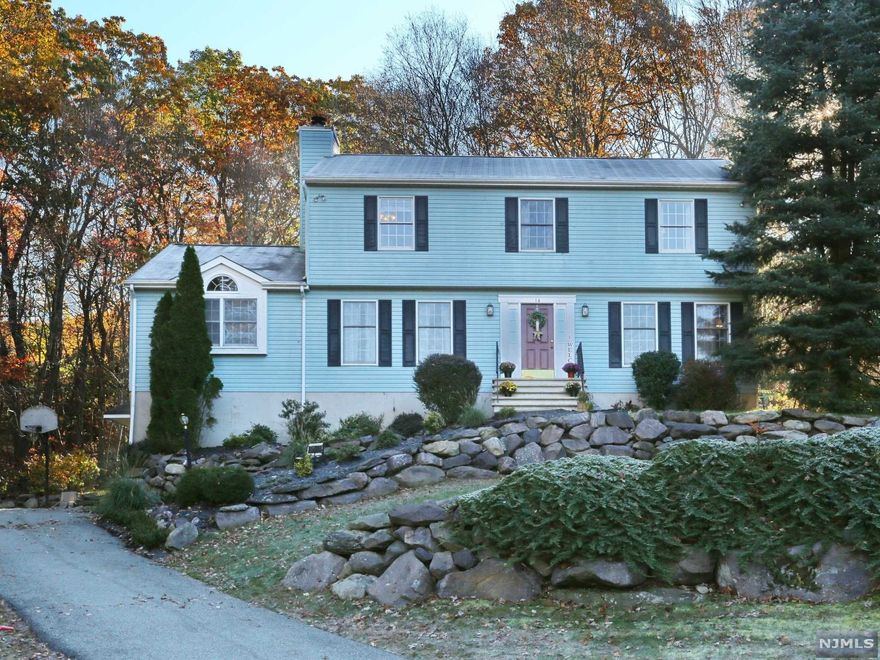 Step into this spacious center hall colonial and you're home! Light and bright, with hardwood floors, and a great room with soaring ceilings and a warm fireplace welcome you. The conveniences are endless: eat-in kitchen plus formal dining room, oversized formal living room, updated powder room, laundry located on the second level with all 4 bedrooms and a main full bathroom. The owner's suite includes a large walk-in closet and en suite bath. Additional living space continues in the two-room finished basement with new carpets, and storage abounds in a third unfinished space. Furnace, well pump, and water softener are each less than 3 years old with no expenses spared. Even a Halo whole-home UV air filtration system is installed for virus-free air quality. The attached two-car garage offers added convenience on rainy or snowy days. Privacy abounds on this nearly one-acre wooded property!