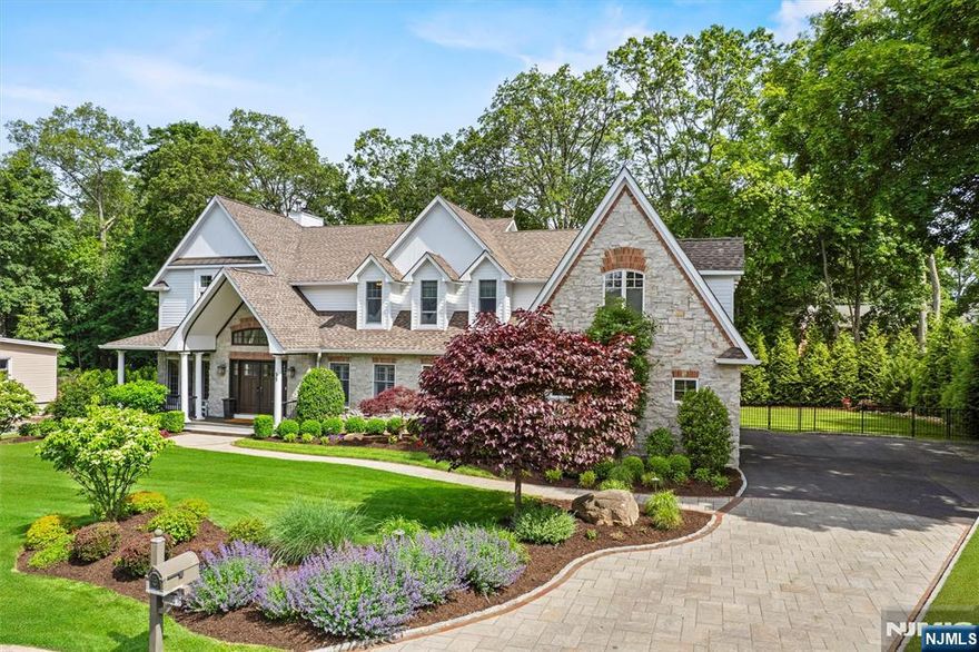 Welcome to this one-of-a-kind custom residence where timeless elegance meets modern comfort. Offering over 5,500 sq ft across three finished levels, this home was designed for those who appreciate beauty, function, and sophistication. A grand two-story foyer with custom staircase and marble floors sets the tone, leading into formal living and dining rooms with Brazilian cherry floors and detailed millwork. The chefâ€™s kitchen features custom cabinetry, a shallow walk-in pantry, butlerâ€™s pantry, and an oversized island, flowing into a stunning family room with fireplace and French doors to a serene rear deck. A ground floor bedroom / home office with ensuite bath, powder room, and an incredible 15â€™ x 25â€™ covered outdoor living room with fireplace, kitchen, and heaters complete the main level. Upstairs, the primary suite offers dual walk-in-closets, a private sitting area, and a spa-worthy bath. Three additional bedrooms, two full baths and laundry are also on this level. The finished lower level includes a summer kitchen, media space, gym, and huge private guest suite. A 3-car garage, impeccably manicured grounds, full smart home integration, and a whole-house generator add to the appeal. Ramsey offers a highly rated school district, and this location is absolutely prime! Close proximity to the high school, elementary school, and Ramsey's charming downtown with easy NYC commuting options.