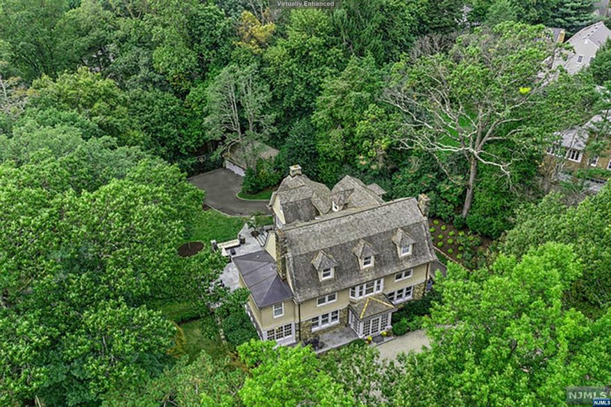 Meticulous top-to-bottom renovated and expanded colonial located in Old Short Hills' iconic Historic District. Endless options for entertaining, this incredible custom home has it all. Luxury finishes throughout feature intricate millwork, paneled walls, high ceilings, paired windows and fireplaces. Pristine property just blocks to Short Hills Train. Circular driveway to vestibule accessing bluestone patio and foyer. Living Room transitions to Office/Sunroom. Dining Room leads to Butler's Pantry, 2nd staircase, Chef's Eat-In Kitchen with high-end appliances, island + breakfast area, and Family Room to expansive bluestone patio and private yard. Primary Suite with fireplace, dressing area, 2 walk-ins, Sitting Room + luxe Bathroom. Junior Suite, 2 more bedrooms, Laundry Room + Full Bath complete 2nd floor. 3rd level with loft area, 3 more bedrooms and 2 full Baths. Lower level Rec Room with dry bar, Media Area, 2nd Laundry Room, Wine Room, half Bath, storage and yard access.